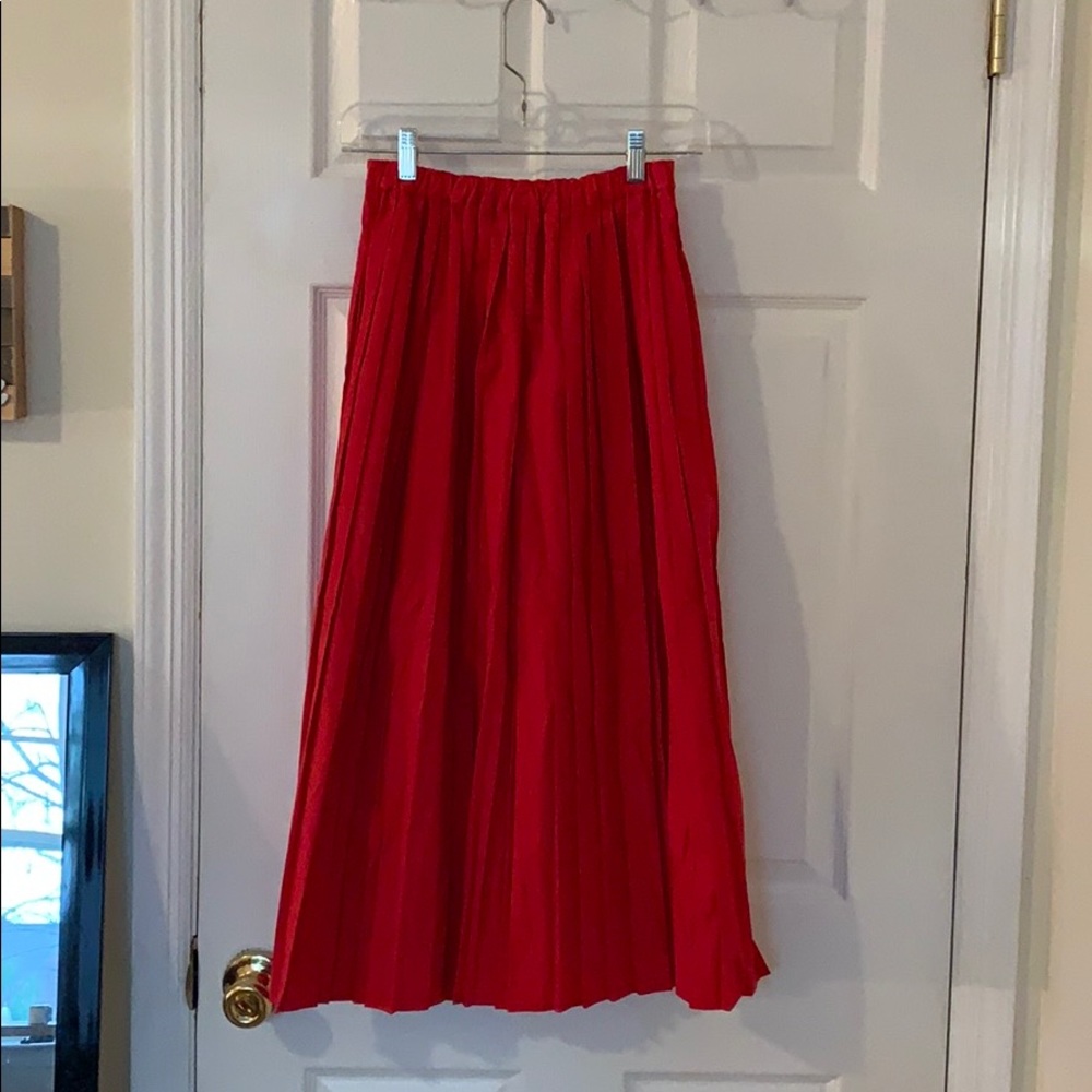 Midi length pleated red skirt
